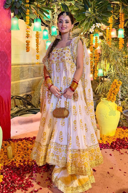 A customised peshwaz in radiant yellow and gold block print on an ivory base, accentuated with traditional gota finishing and intricate gota work on the bodice—an exclusive creation by The PinkTree Company.