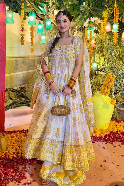A customised peshwaz in radiant yellow and gold block print on an ivory base, accentuated with traditional gota finishing and intricate gota work on the bodice—an exclusive creation by The PinkTree Company.