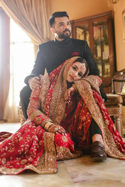 A classic red bridal for Barat, timelessly handcrafted with zardozi, sitara, kamdani, and dabka. The shirt and dupatta are finished with elegant chatapatti, while the dupatta features an all-over handworked jaal and richly embellished borders.