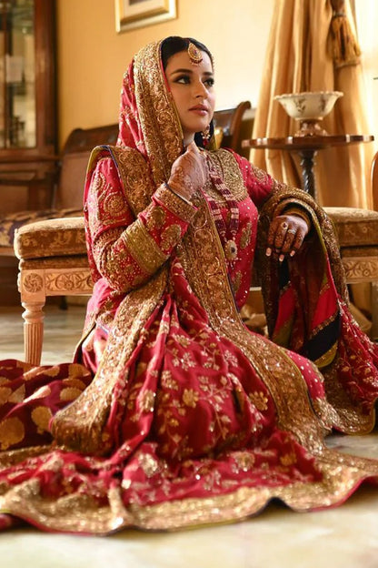 A classic red bridal for Barat, timelessly handcrafted with zardozi, sitara, kamdani, and dabka. The shirt and dupatta are finished with elegant chatapatti, while the dupatta features an all-over handworked jaal and richly embellished borders.