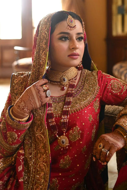 A classic red bridal for Barat, timelessly handcrafted with zardozi, sitara, kamdani, and dabka. The shirt and dupatta are finished with elegant chatapatti, while the dupatta features an all-over handworked jaal and richly embellished borders.