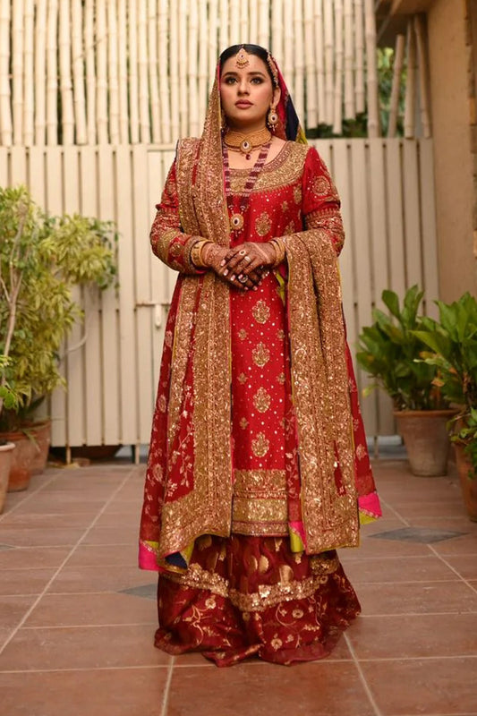 A classic red bridal for Barat, timelessly handcrafted with zardozi, sitara, kamdani, and dabka. The shirt and dupatta are finished with elegant chatapatti, while the dupatta features an all-over handworked jaal and richly embellished borders.